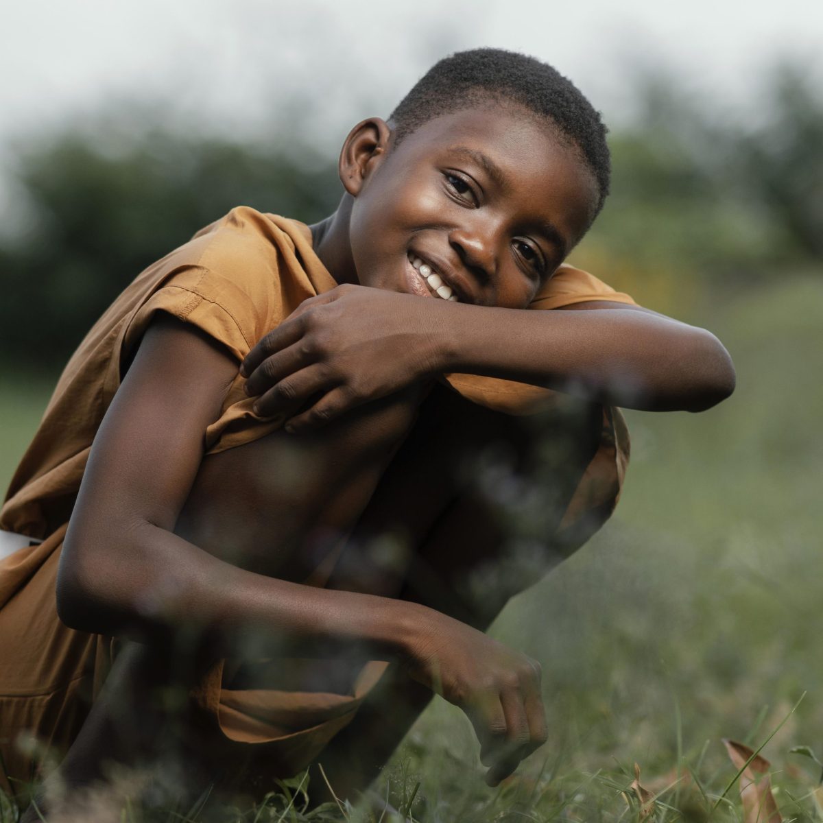 smiley-young-african-boy-standing-field smiley-young-african-boy-standing-field